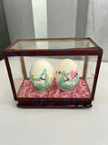 Geisha figurine, oval landscape plaque, and two painted eggs in glass display - thumbnail 4 of 6