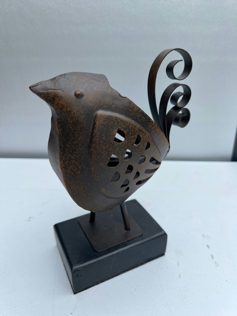 Rusty metal bird sculpture on a black pedestal - image 1 of 3