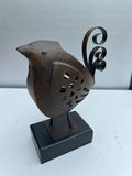 Rusty metal bird sculpture on a black pedestal - thumbnail 1 of 3