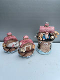Three ceramic figurines: salt and pepper shakers pink-roofed houses and a brick-tower scene - thumbnail 1 of 5