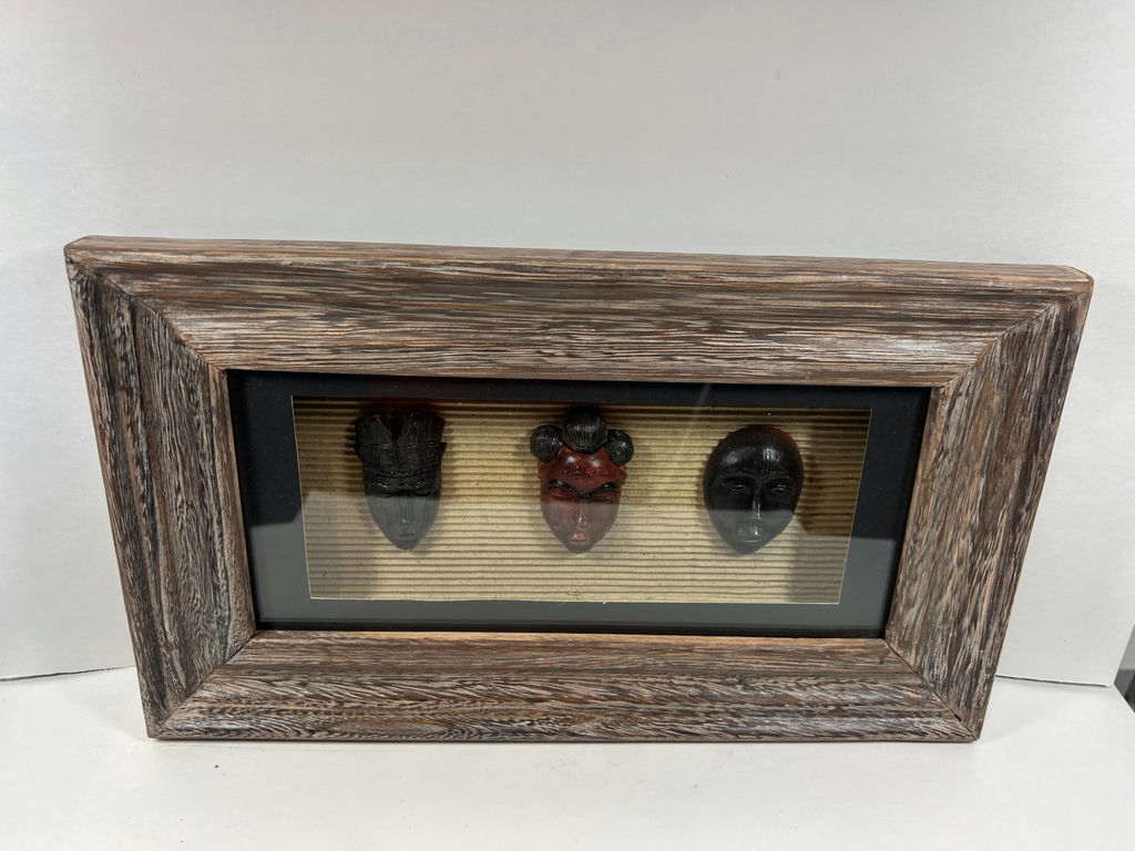 Three carved masks in a rustic framed display - image 1 of 3