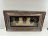 Three carved masks in a rustic framed display - thumbnail 1 of 3