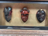 Three carved masks in a rustic framed display - thumbnail 2 of 3