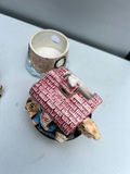 Three ceramic figurines: salt and pepper shakers pink-roofed houses and a brick-tower scene - thumbnail 5 of 5