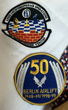 Military Memorabilia Collection with Flags, Patches, Wooden Plaque, and Decorative Plate - thumbnail 3 of 9