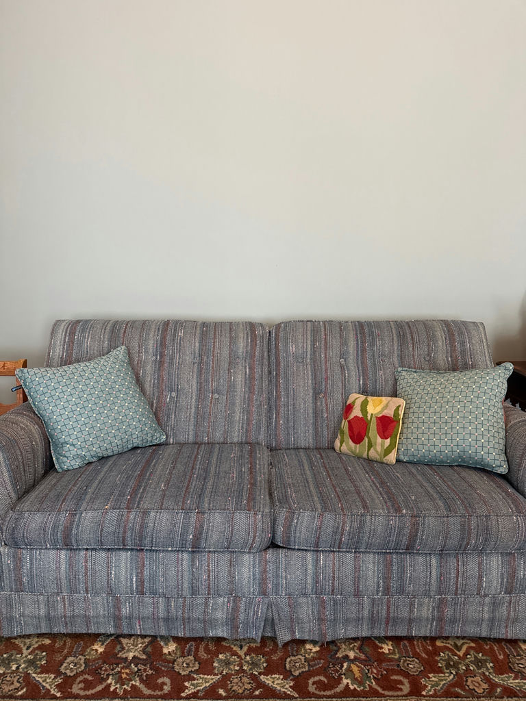Blue striped sleep sofa with decorative throw pillows - image 1 of 2
