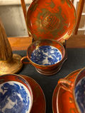 Orange-red porcelain teacups with blue interiors, matching saucers and plate, plus a gold vase - thumbnail 2 of 4