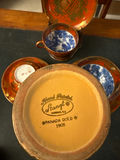 Orange-red porcelain teacups with blue interiors, matching saucers and plate, plus a gold vase - thumbnail 4 of 4