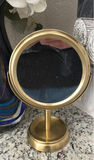 Hydrangea bouquet in blue glass vase with decorative bottles and brass mirror - thumbnail 5 of 5