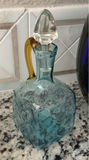Hydrangea bouquet in blue glass vase with decorative bottles and brass mirror - thumbnail 3 of 5