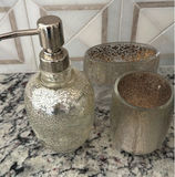 Hydrangea bouquet in blue glass vase with decorative bottles and brass mirror - thumbnail 2 of 5