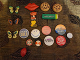 Assorted decorative pins, badges, magnets, and small trinkets - thumbnail 1 of 7