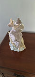 Porcelain Angel Figurine on Dolphin Base - thumbnail 1 of 3