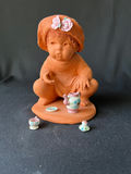 Terracotta baby with miniature tea set and white winged angel figurine - thumbnail 2 of 6
