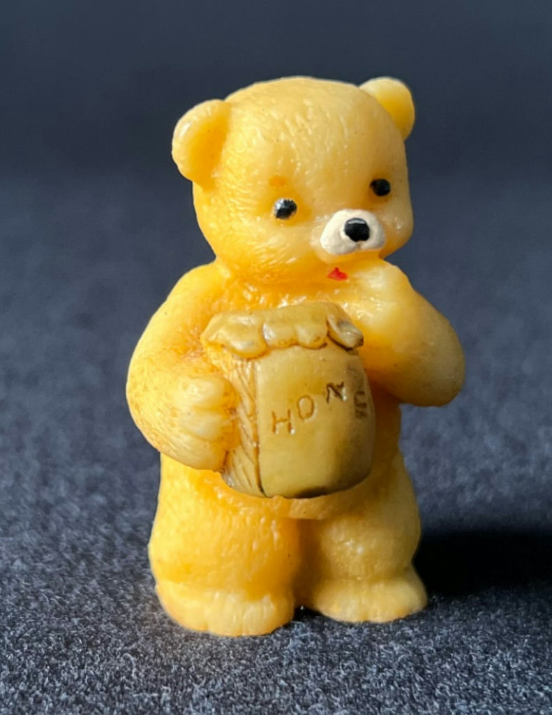 Yellow teddy bear figurine holding a honey jar - image 1 of 8