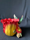 Colorful flower sculpture with hummingbird and cowboy figurine - thumbnail 1 of 11