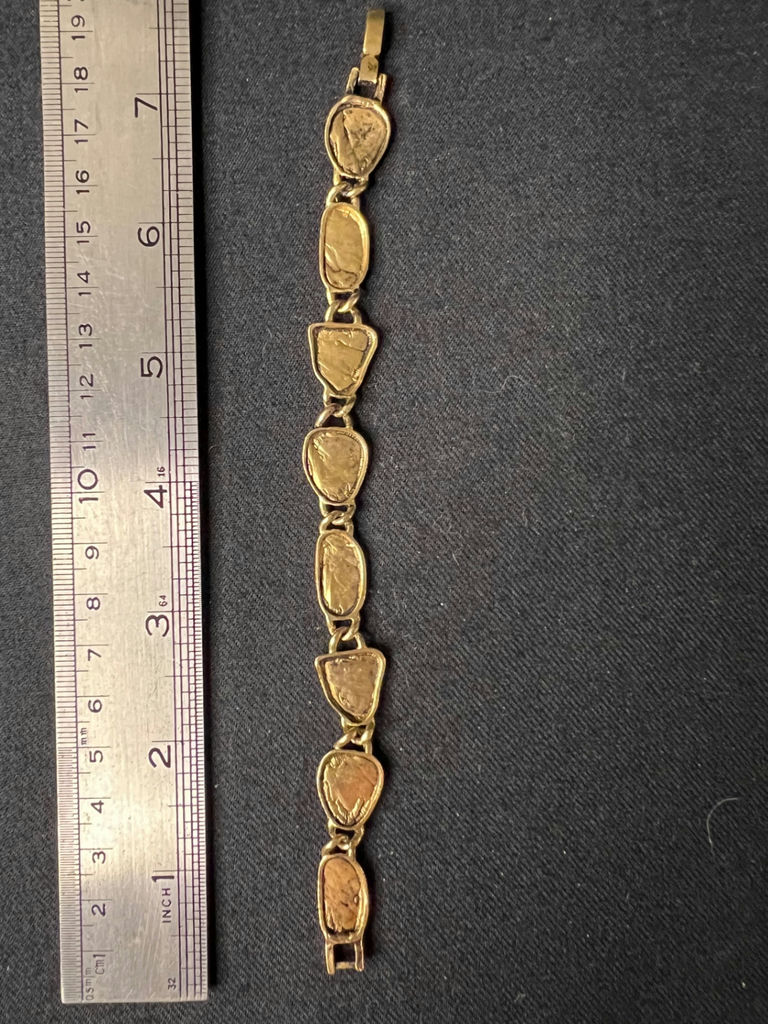 Gold-tone bracelet with engraved shield links, beaded hoop earrings, and a wire bow ornament - image 5 of 10
