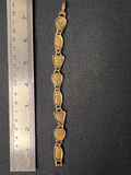 Gold-tone bracelet with engraved shield links, beaded hoop earrings, and a wire bow ornament - thumbnail 5 of 10