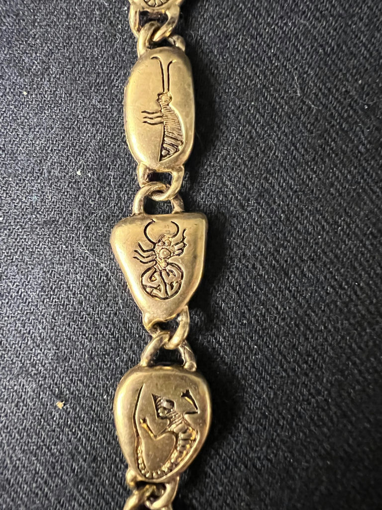 Gold-tone bracelet with engraved shield links, beaded hoop earrings, and a wire bow ornament - image 6 of 10