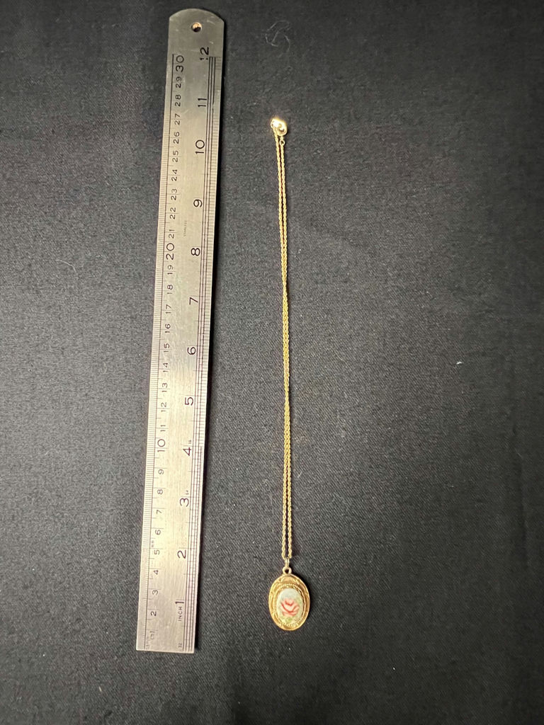 Gold-tone cameo pendant necklace with floral center, purple chip earrings, and two-tone circular earrings - image 2 of 11