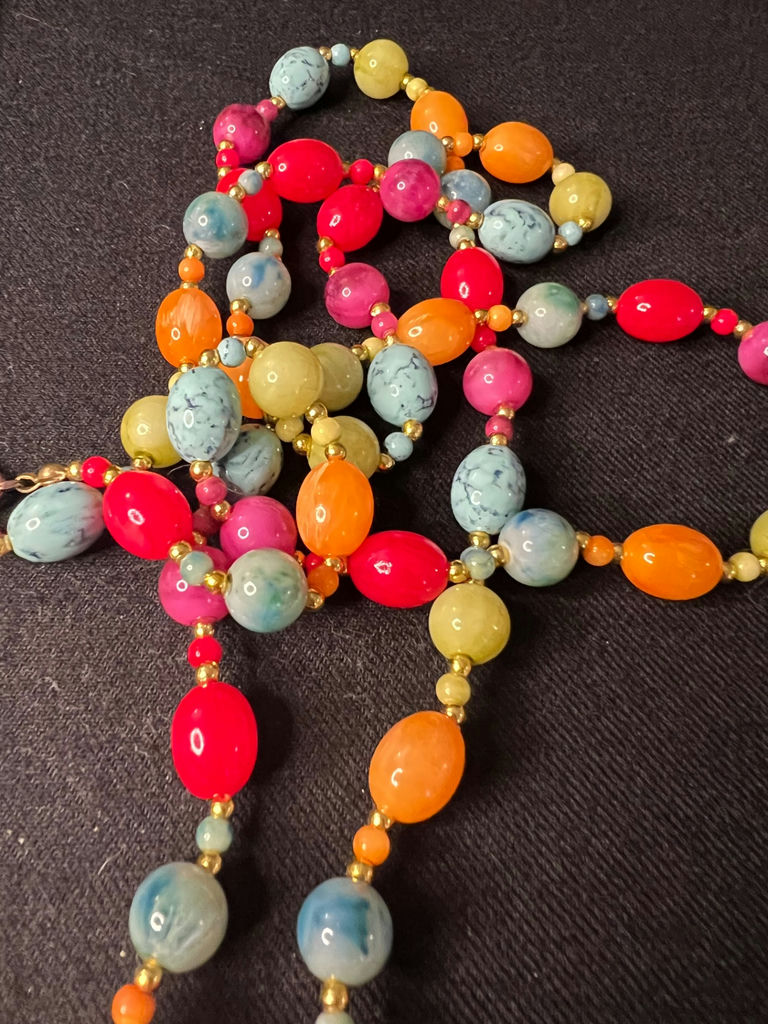 Three necklaces: gold-tone pendant necklace, silver-toned necklace, and multicolor beaded necklace - image 10 of 11