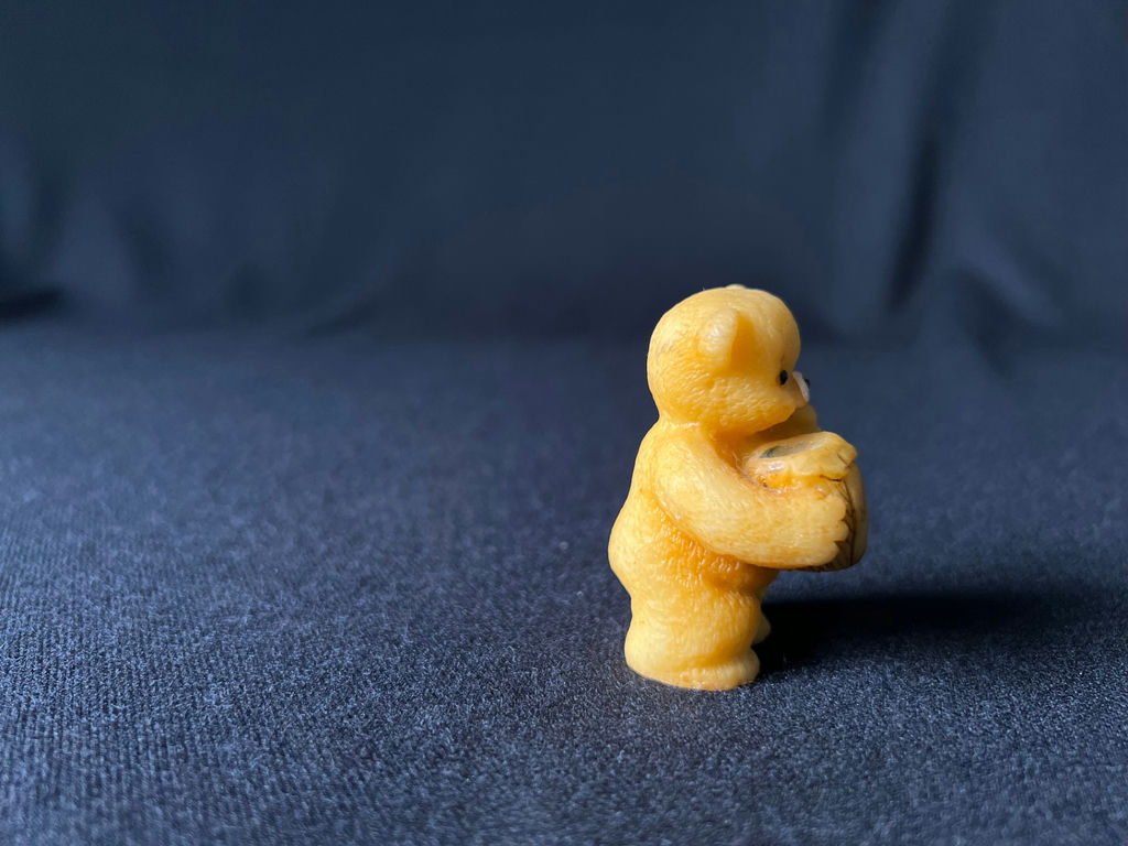 Yellow teddy bear figurine holding a honey jar - image 7 of 8