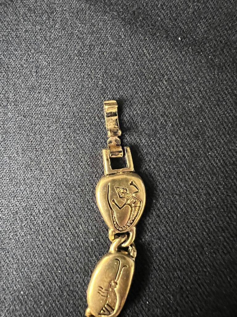 Gold-tone bracelet with engraved shield links, beaded hoop earrings, and a wire bow ornament - image 7 of 10