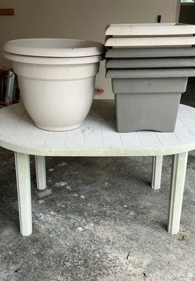 Oval plastic table with assorted planters and pots - Image 1 of 4