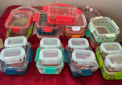 Assorted glass and plastic food storage containers with colorful lids - Image 1 of 6