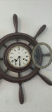 Vintage wall-mounted ship wheel clock, antique telephone, and wooden wall rack - thumbnail 6 of 8