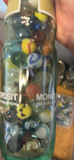 Assorted glass marbles in jars, bowls, and bottles - thumbnail 5 of 5