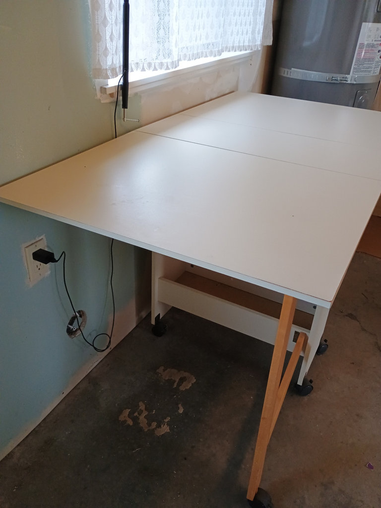 White foldable table with central pedestal and wooden legs on casters - image 3 of 6