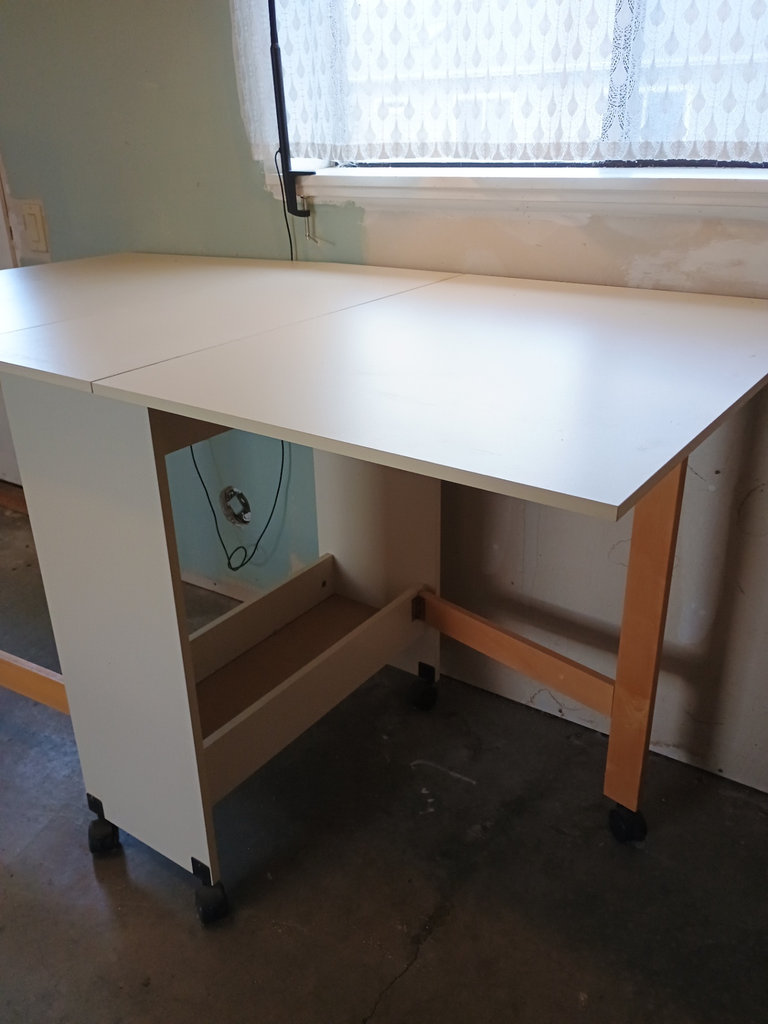White foldable table with central pedestal and wooden legs on casters - image 4 of 6