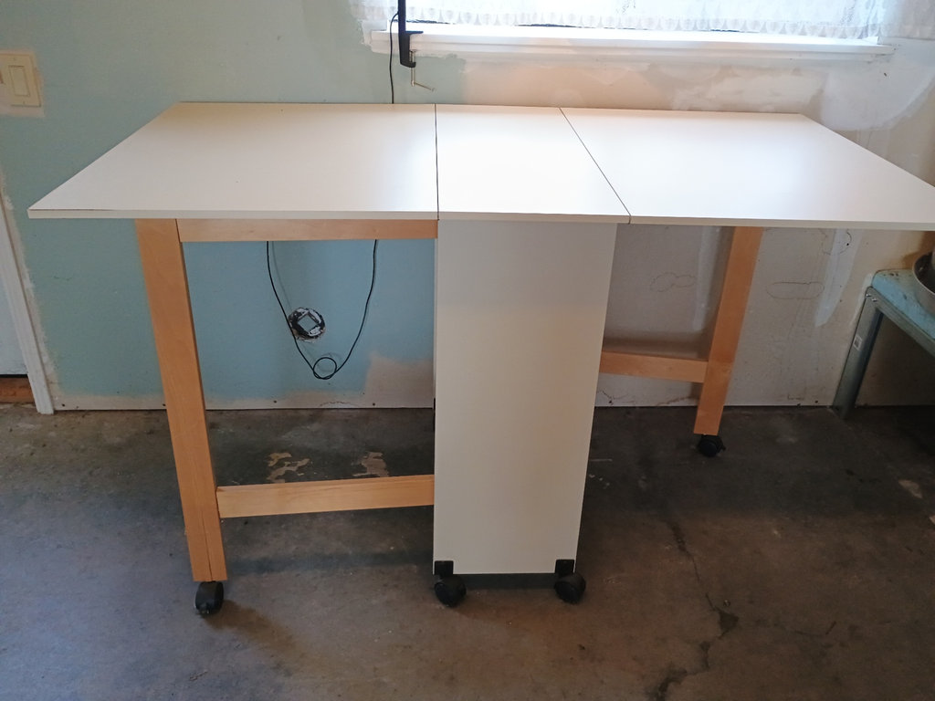 White foldable table with central pedestal and wooden legs on casters - image 5 of 6