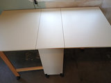 White foldable table with central pedestal and wooden legs on casters - thumbnail 2 of 6
