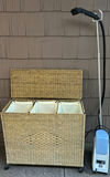 Wicker three-compartment laundry hamper with a portable garment steamer - thumbnail 2 of 4