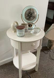 White round end table with vintage fan and assorted decorative items - thumbnail 1 of 6