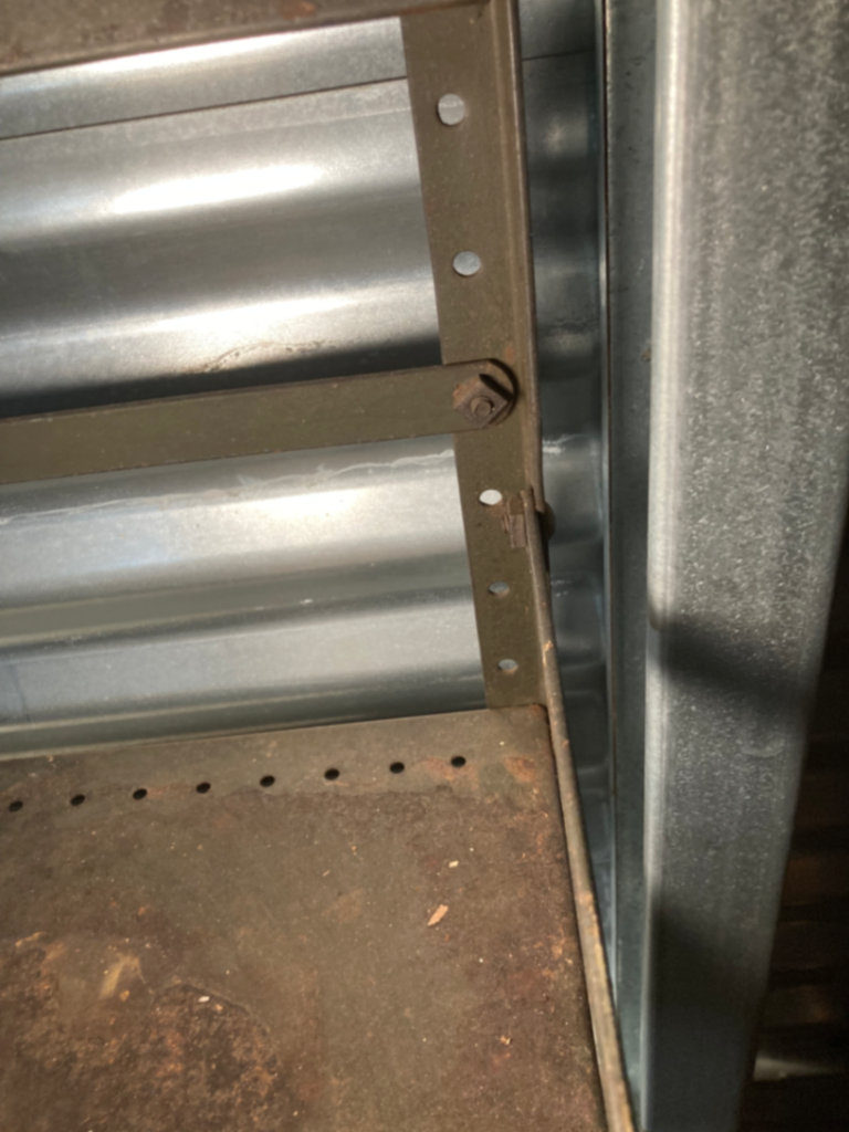 Industrial metal shelving unit with Mohawk Beverages sign - image 4 of 5