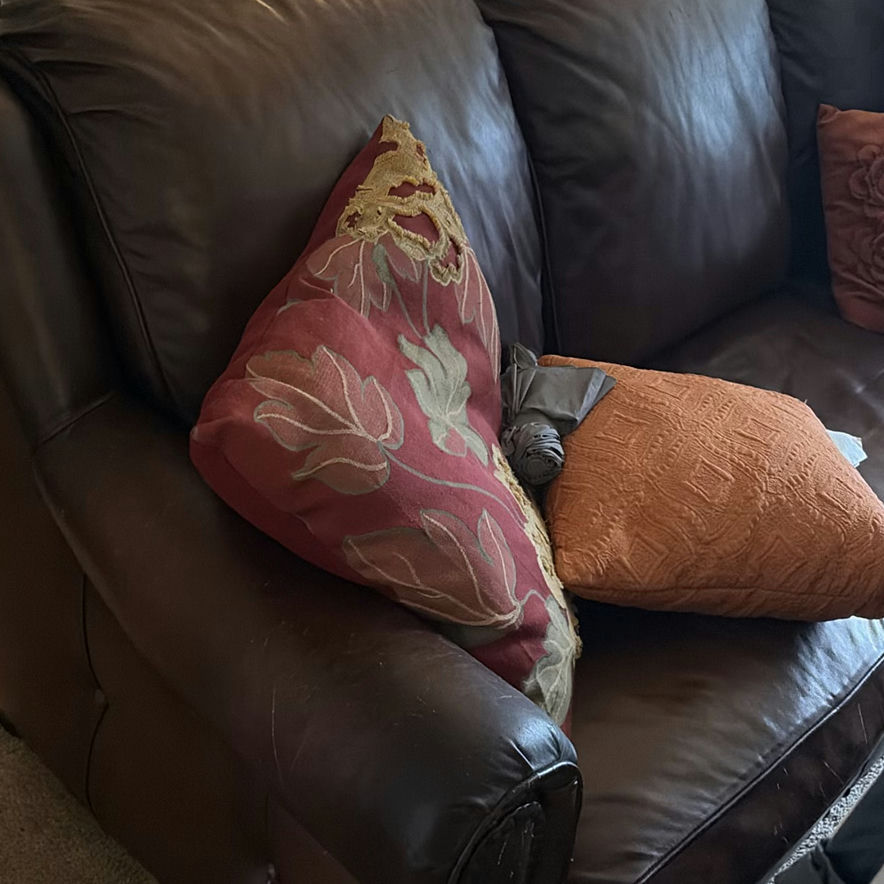 Brown Leather Sofa with Orange and Red Throw Pillows - image 2 of 3
