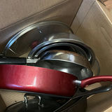 Red covered saucepan with glass lid and assorted cookware - thumbnail 3 of 3