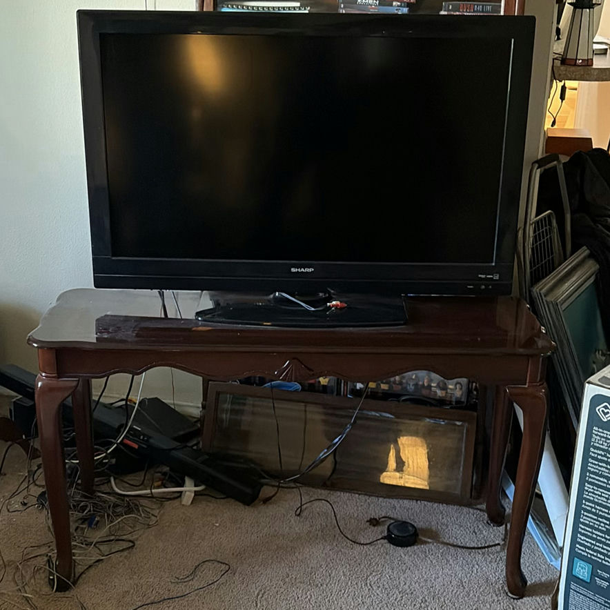Sharp LCD TV with wooden console table - image 1 of 6
