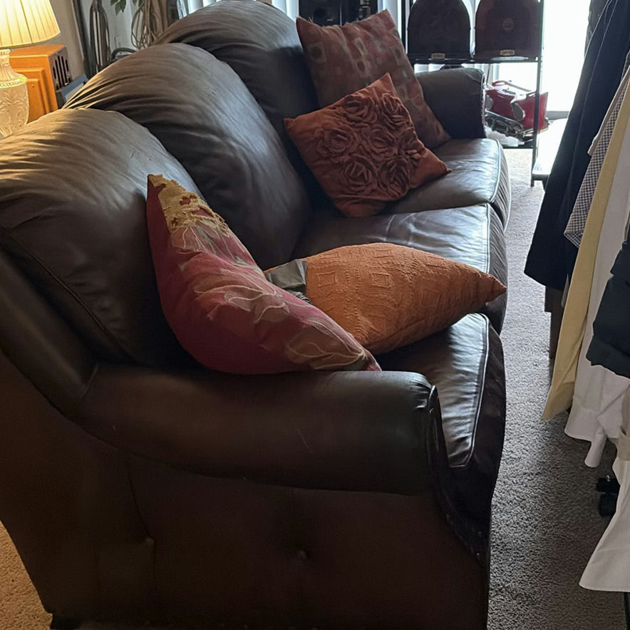Brown Leather Sofa with Orange and Red Throw Pillows - image 1 of 3