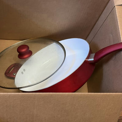 Red covered saucepan with glass lid and assorted cookware - Image 1 of 3