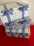 Three decorative pastel gift boxes with blue ribbons - thumbnail 1 of 1