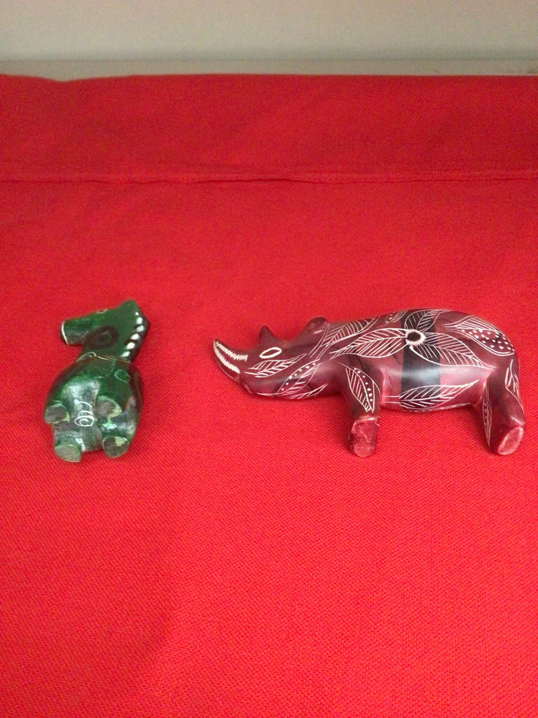 Green carved canine figurine and red leaf-patterned boar figurine - image 2 of 2