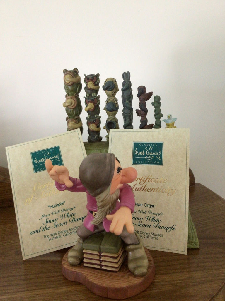 Dopey figurine with a decorative green pipe organ and totem-pole sculptures - image 1 of 6