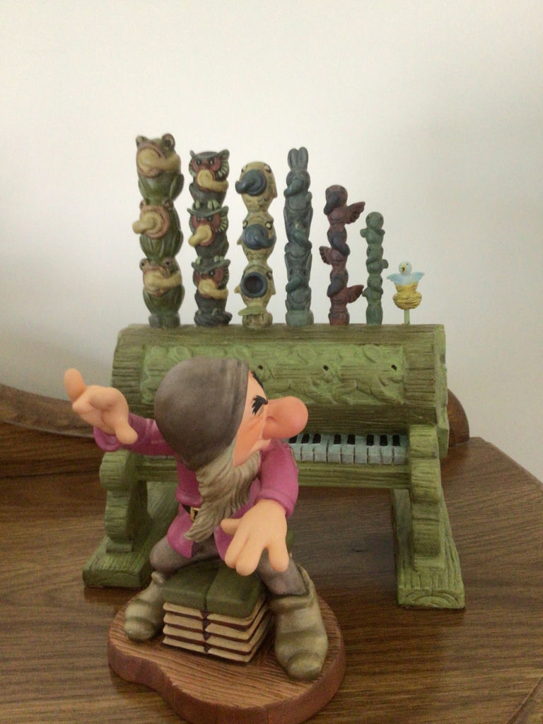 Dopey figurine with a decorative green pipe organ and totem-pole sculptures - image 2 of 6