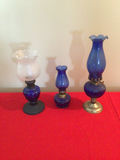 Three cobalt blue glass hurricane lamps (one with white frosted shade) - thumbnail 1 of 2