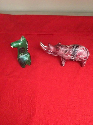 Green carved canine figurine and red leaf-patterned boar figurine - Image 1 of 2