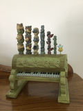 Dopey figurine with a decorative green pipe organ and totem-pole sculptures - thumbnail 3 of 6